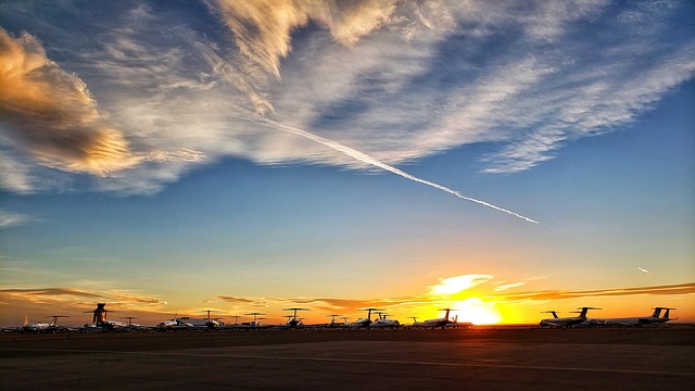 private jet wing above clouds with soft gold sunlight