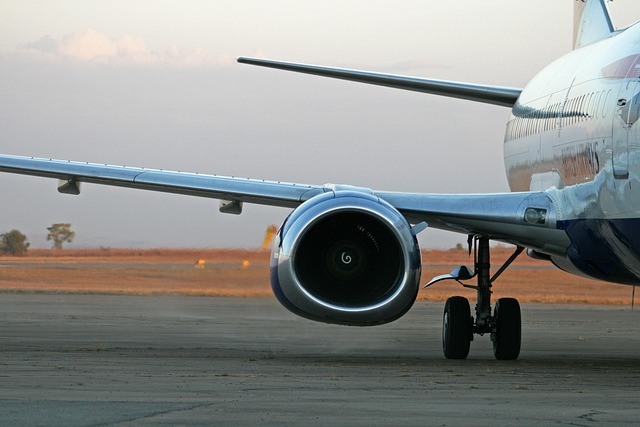 private jet wing above clouds with warm sunlight